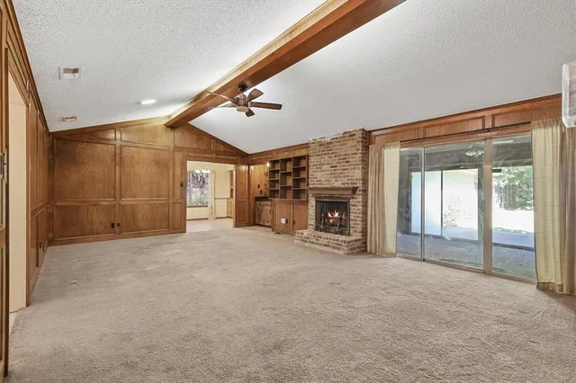 a view of an empty room with a fireplace