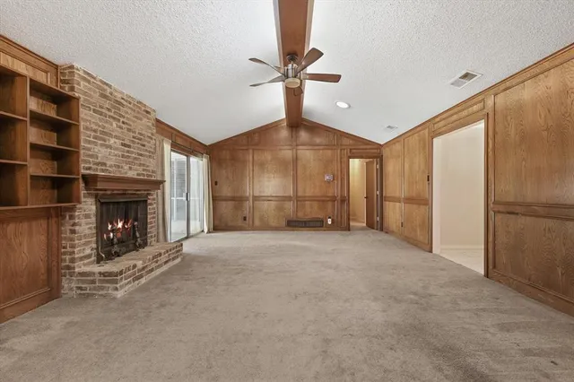 a large kitchen with stainless steel appliances granite countertop a stove top oven a sink dishwasher and cabinets with wooden floor