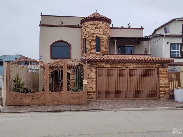 a view of a house with iron fence