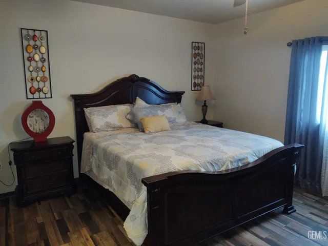 a large bed sitting in a bedroom next to a window