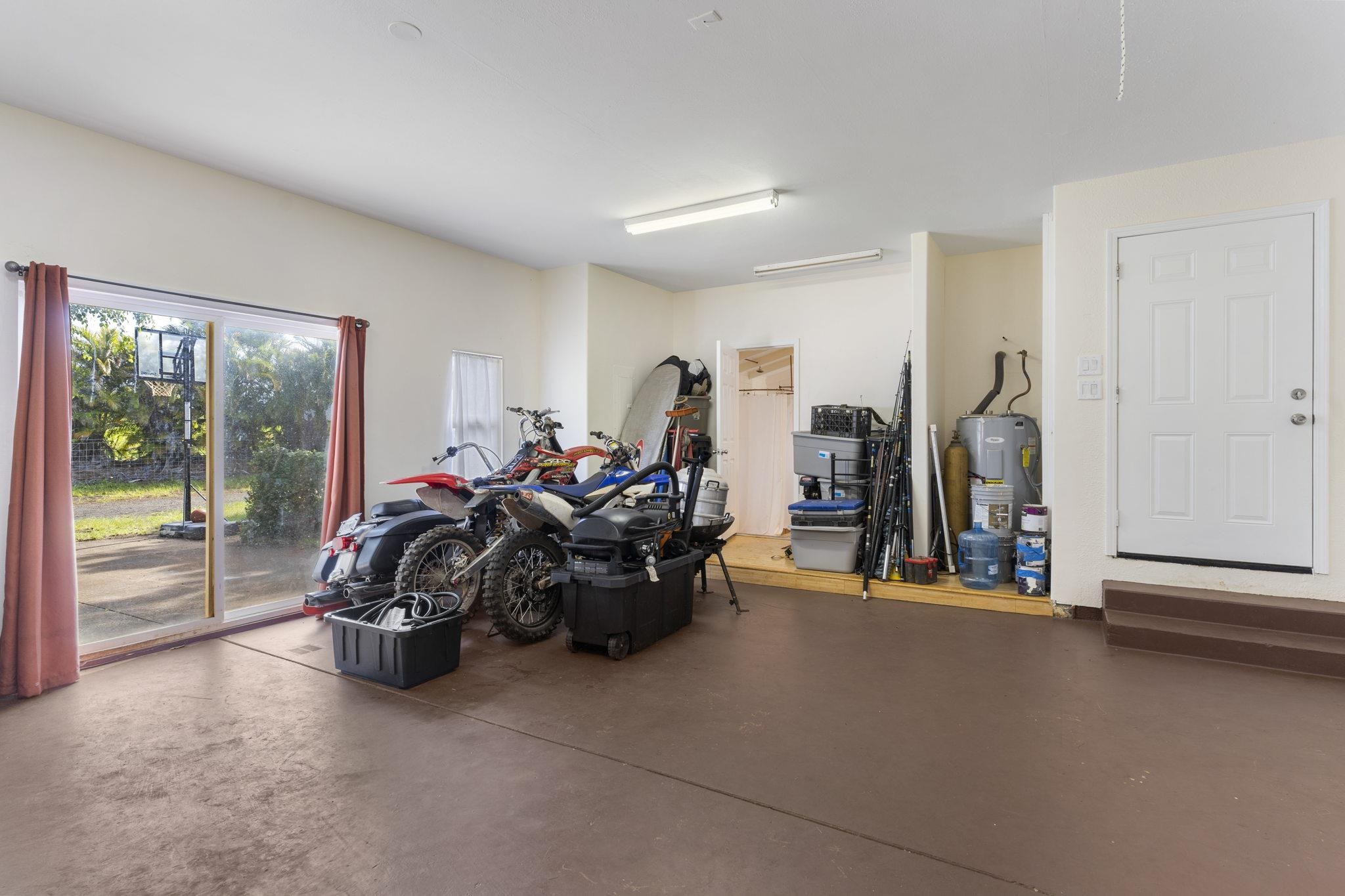 89 Nahele Road Haiku, HI 96708 - Photo 14 of 30 a living room with furniture a large window and gym equipment