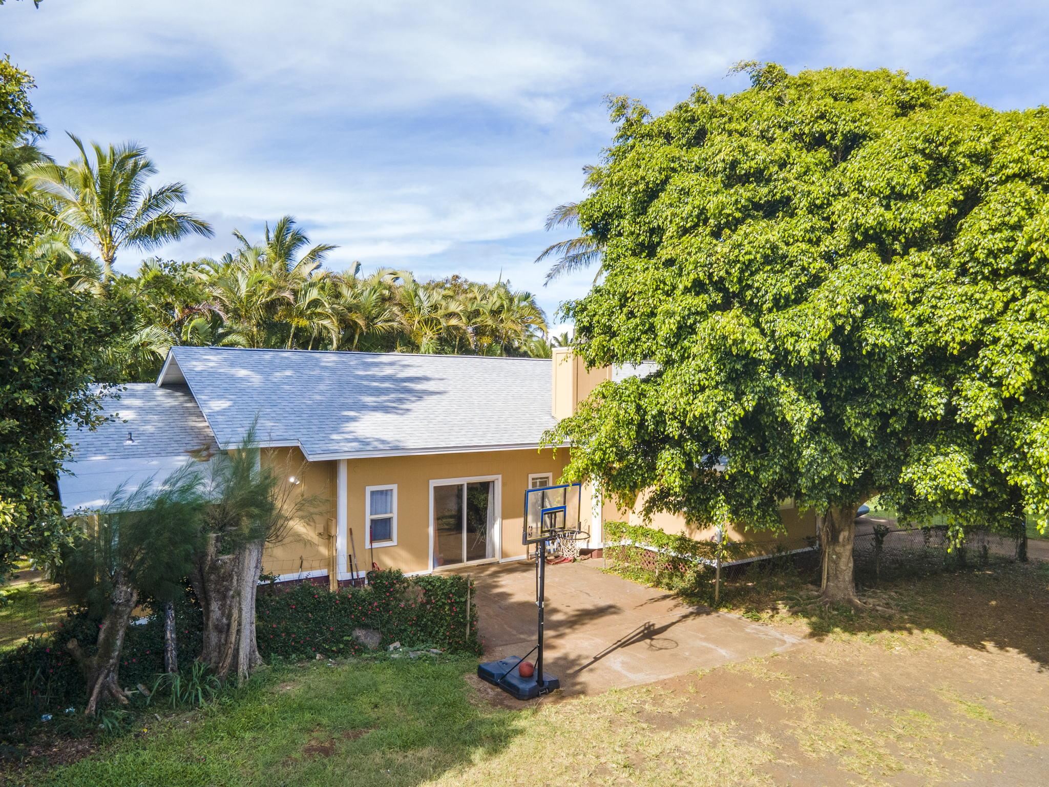 89 Nahele Road Haiku, HI 96708 - Photo 3 of 30 a front view of a house with a yard and garage