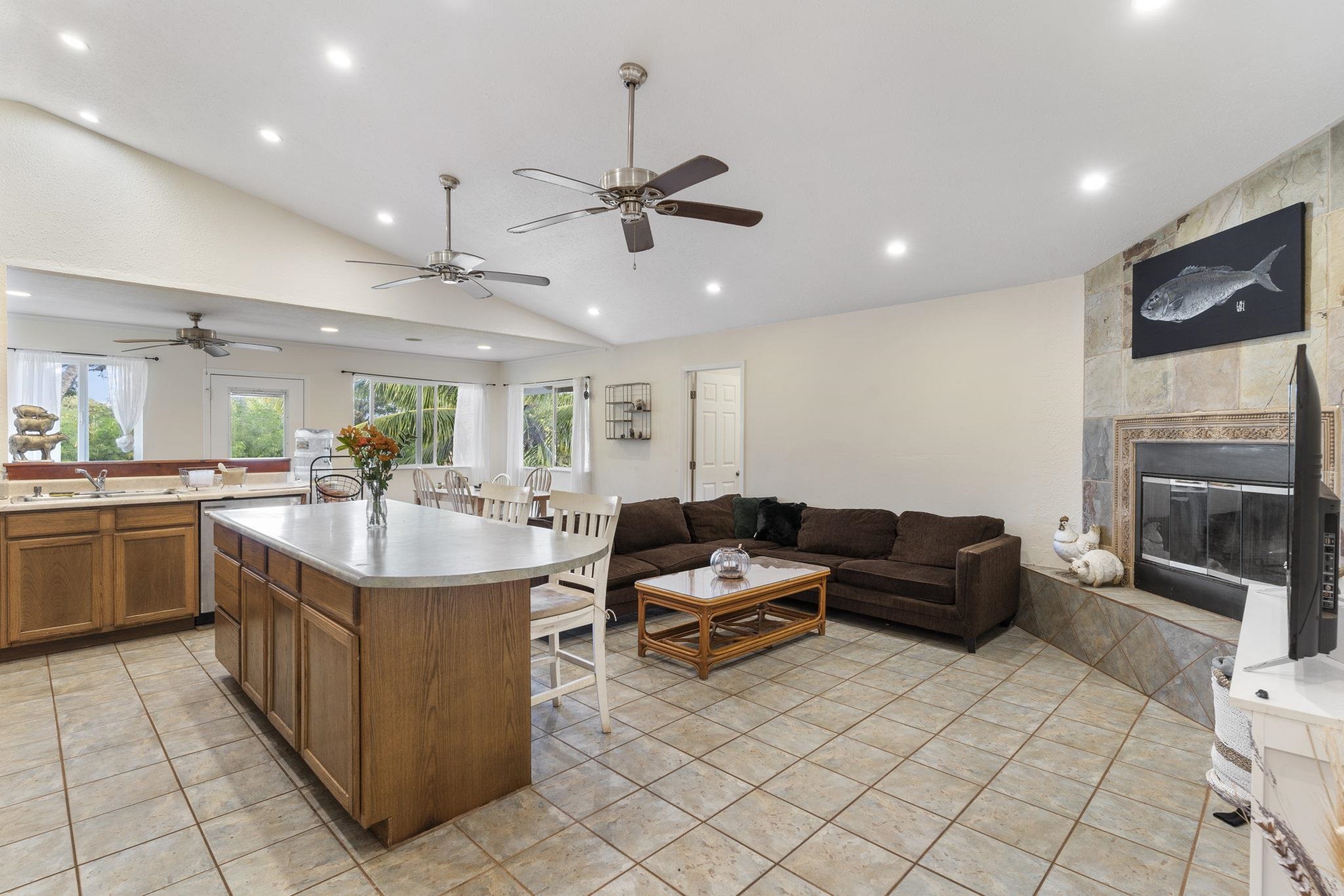 89 Nahele Road Haiku, HI 96708 - Photo 4 of 30 a living room with furniture a fireplace and a flat screen tv