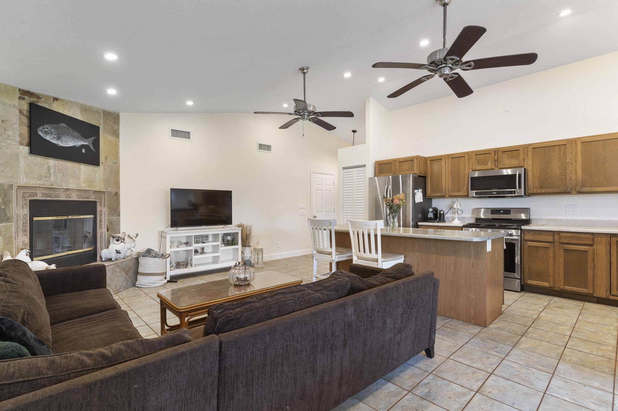 89 Nahele Road Haiku, HI 96708 - Photo 5 of 30 a living room with stainless steel appliances furniture a fireplace a flat screen tv and a window