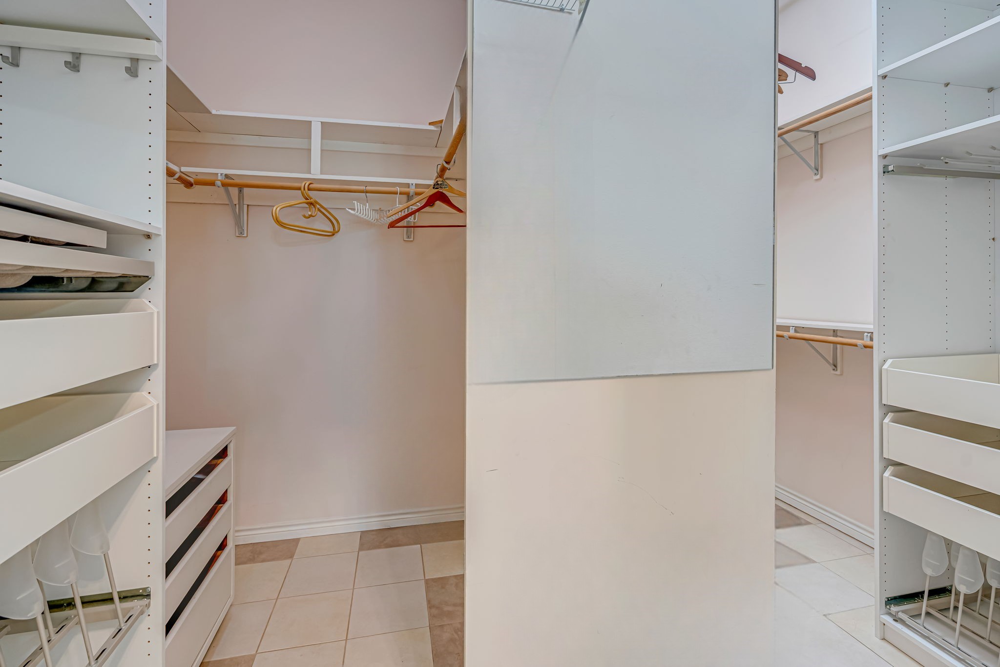 4028 Crosby Cedar Bayou Road Baytown, TX 77521 - Photo 25 of 35 Primary walk-in closet with custom organizers—shelves, drawers, pull-outs, and double hanging rods for maximum storage.