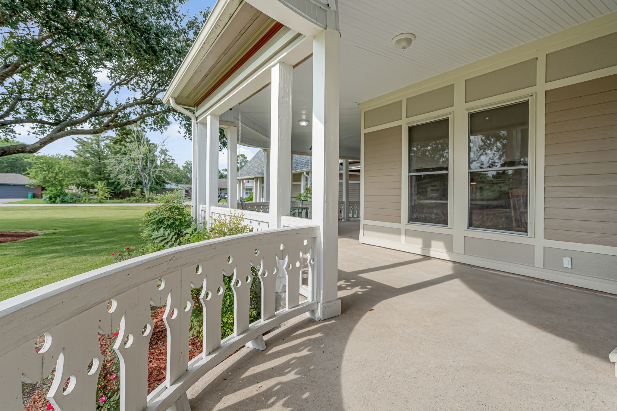 4028 Crosby Cedar Bayou Road Baytown, TX 77521 - Photo 4 of 35 A refined curve in the wraparound veranda showcases classic Victorian detail—from the gingerbread balustrade to the beadboard ceiling and tapered posts. This tranquil perch captures sweeping views of the manicured grounds and century oaks—perfect for morning coffee or twilight conversations.