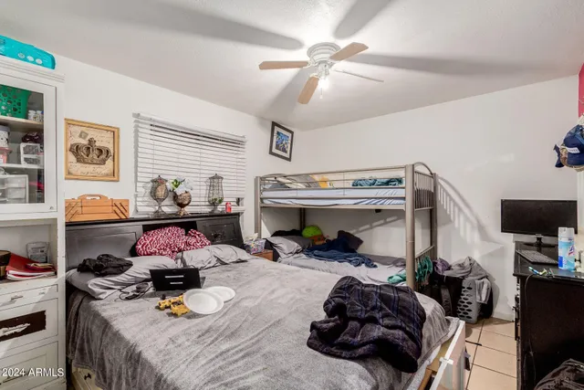 a bedroom with a bed and a tv