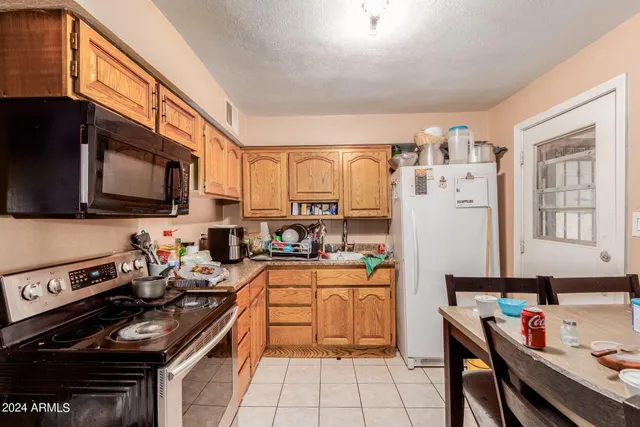 a kitchen with stainless steel appliances a stove sink microwave and cabinets