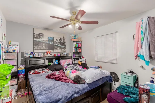 a bed room with a bed and a chandelier