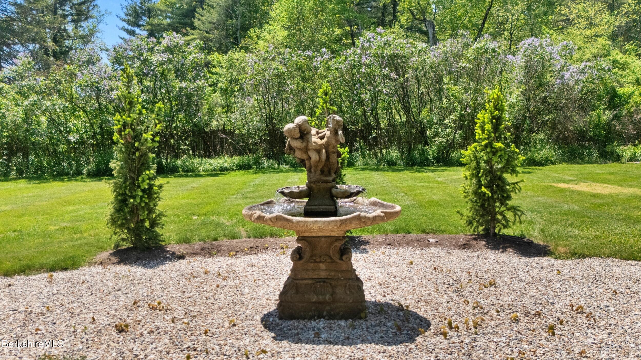 2650 Swamp Road Richmond, MA 01254 - Photo 3 of 49 a front view of a garden with a slide