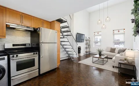 a kitchen with stainless steel appliances a stove a refrigerator and cabinets