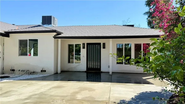 a view of a house with potted plants