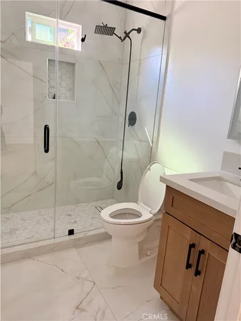 a bathroom with a sink toilet and shower