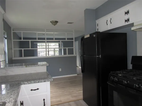 a kitchen with a refrigerator and a sink