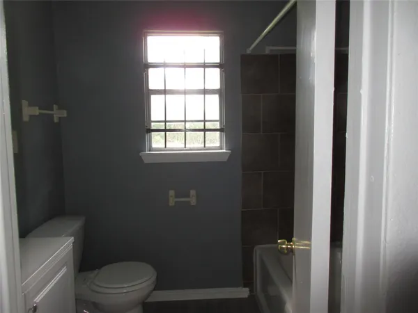a bathroom with a toilet a sink and shower