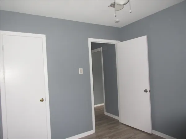 a view of a hallway with a chandelier fan
