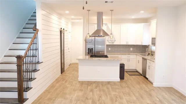 a view of a kitchen with wooden floor and window