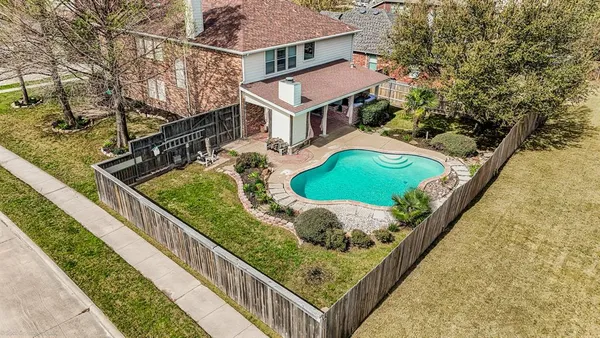 a aerial view of a house with a garden and trees