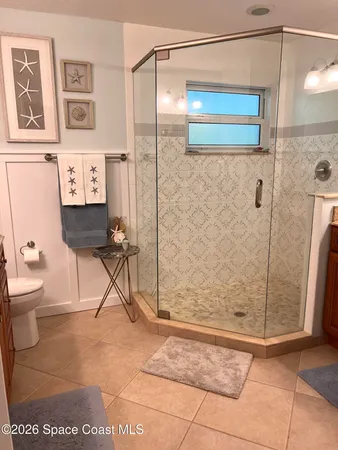 a bathroom with a shower a toilet and a sink