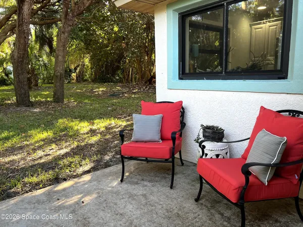a view of a two chairs in the patio