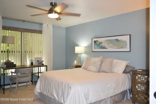 a bedroom with a bed and a large mirror