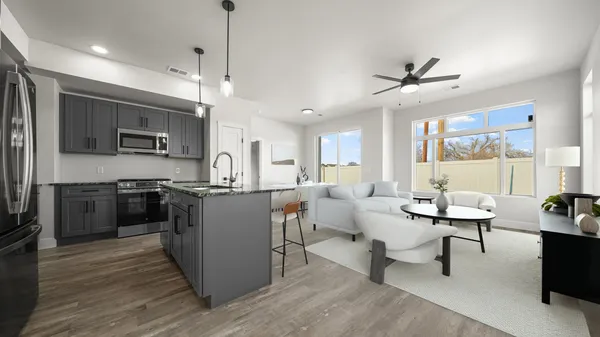 a large kitchen with kitchen island a sink a counter space stainless steel appliances and a window