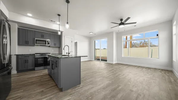 a large kitchen with kitchen island a large counter space a sink appliances and cabinets