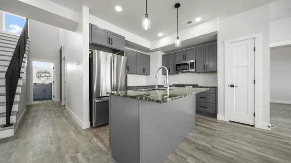 a kitchen with refrigerator and cabinets