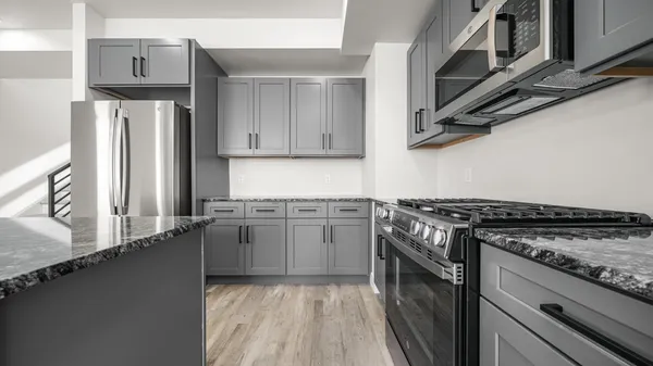 a kitchen with stainless steel appliances granite countertop a stove and a sink