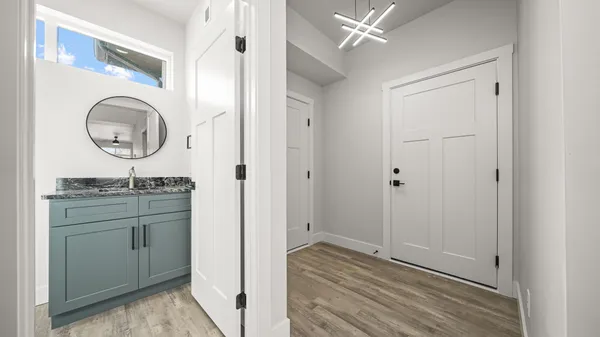 a bathroom with a granite countertop sink mirror and vanity