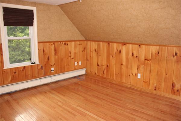 689 Walnut Plain Road Rochester, MA 02770 - Photo 11 of 22 a view of an empty room with wooden floor and a window