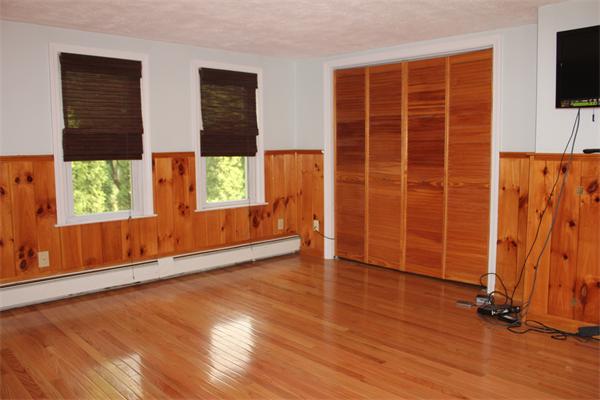 689 Walnut Plain Road Rochester, MA 02770 - Photo 13 of 22 an empty room with wooden floor and windows