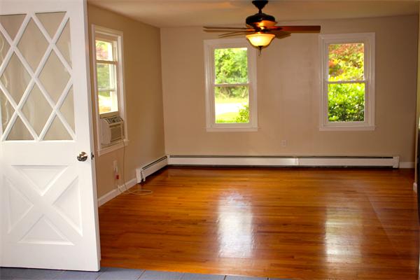 689 Walnut Plain Road Rochester, MA 02770 - Photo 4 of 22 a view of a livingroom with wooden floor and a window