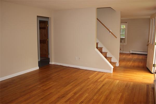 689 Walnut Plain Road Rochester, MA 02770 - Photo 6 of 22 a view of a hallway with wooden floor and staircase