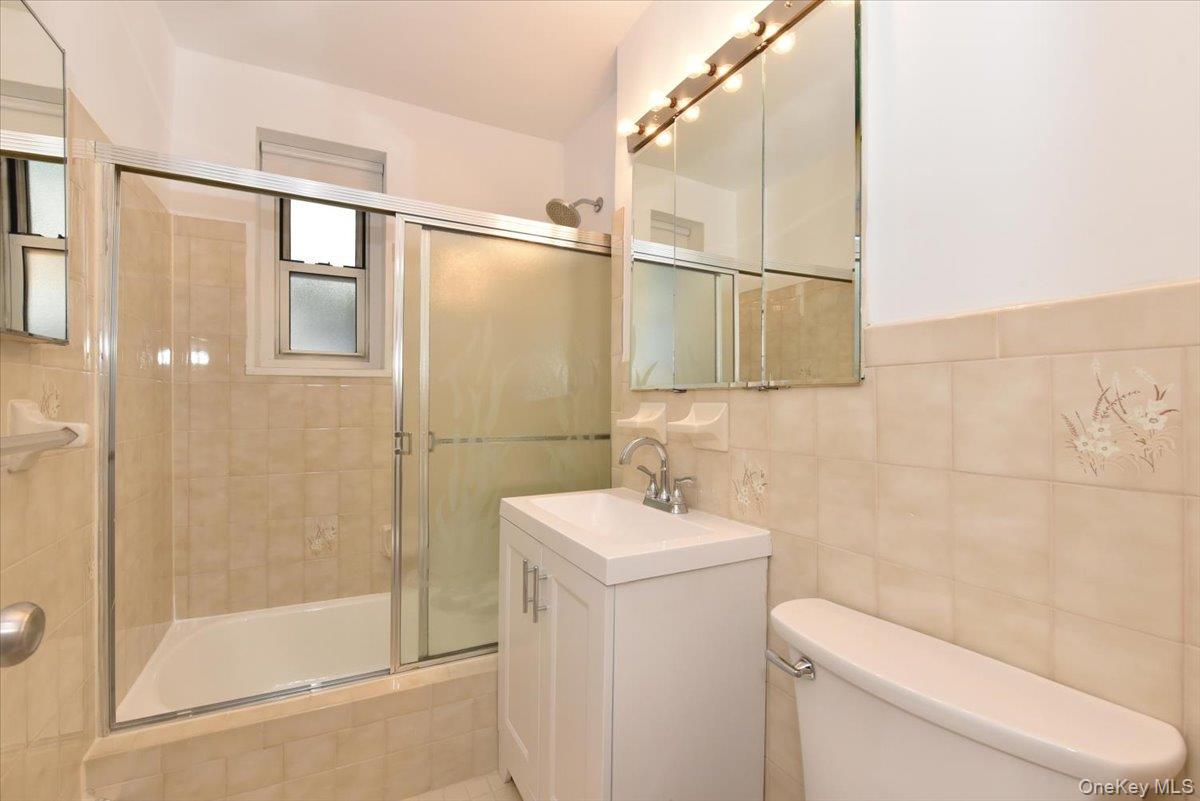 195 South Middle Neck Road, Unit 2L Great Neck, NY 11021 - Photo 15 of 36 a bathroom with a sink a toilet and shower