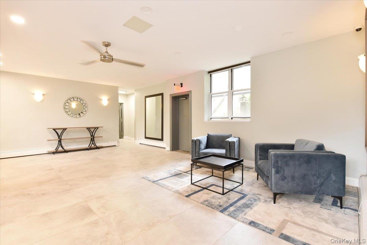 195 South Middle Neck Road, Unit 2L Great Neck, NY 11021 - Photo 23 of 36 a living room with furniture and a window