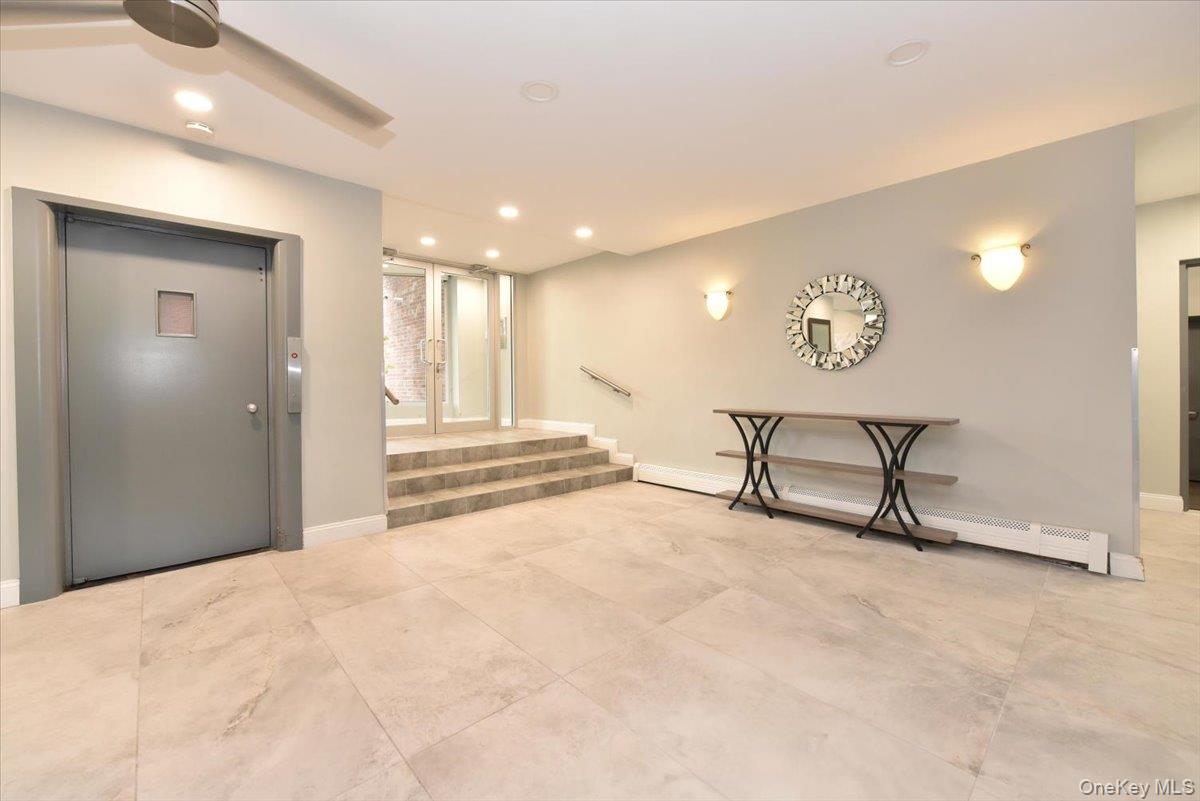 195 South Middle Neck Road, Unit 2L Great Neck, NY 11021 - Photo 24 of 36 a view of a livingroom with furniture and windows