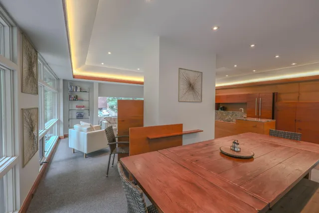 a dining room with furniture and wooden floor