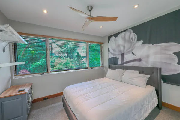 a bedroom with a large bed and a large window