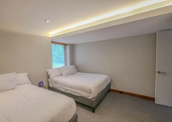 a bedroom with two beds and a night stand