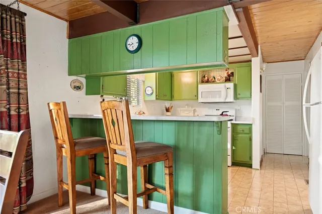 a view of kitchen with cabinets and a refrigerator