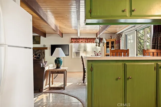 a dining room with furniture and a potted plant