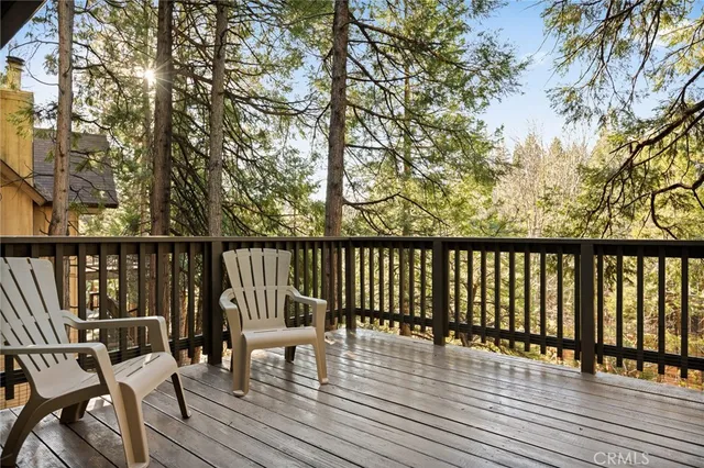 a view of balcony with wooden floor and outdoor seating