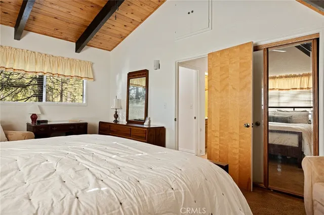 a bedroom with a bed and a large window