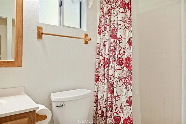 a white toilet sitting next to a shower curtain