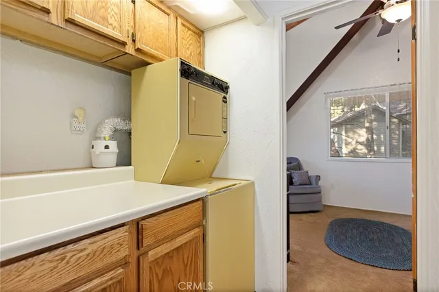 a hallway with a stove a microwave and cabinets