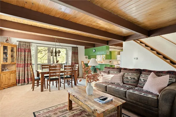 a living room with lots of furniture and a large window