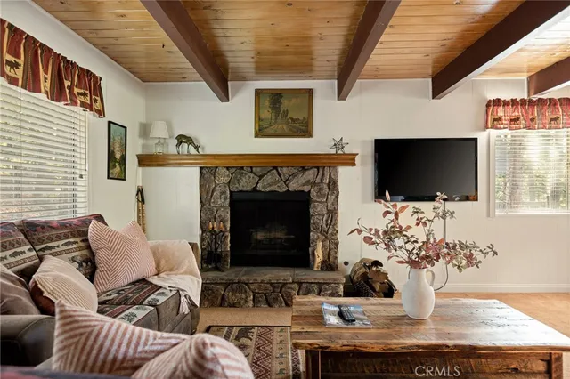 a living room with furniture flat screen tv and a fireplace
