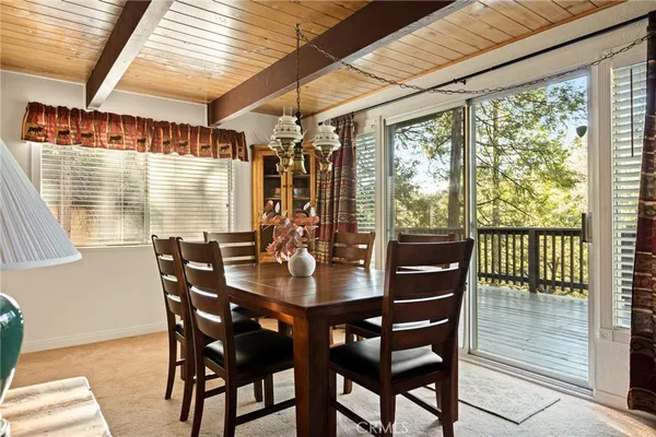 a view of a dining room with furniture and window