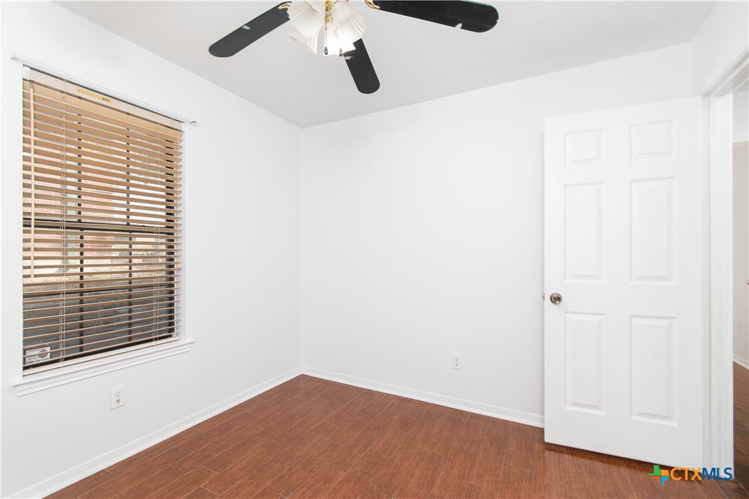 5420 Williams Drive Temple, TX 76502 - Photo 16 of 24 a view of an empty room with wooden floor and a window